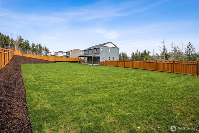 view of yard with a fenced backyard