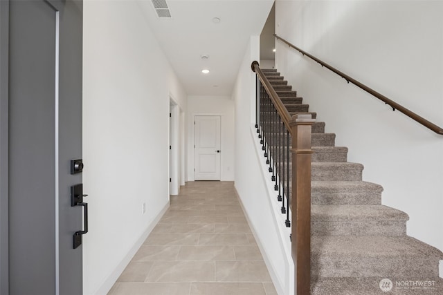 staircase with tile patterned floors, recessed lighting, baseboards, and visible vents