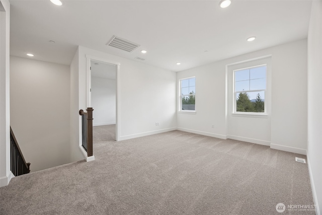 unfurnished room with visible vents, recessed lighting, and light colored carpet