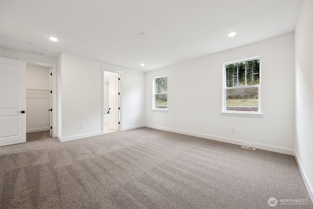 unfurnished room featuring recessed lighting, carpet, and baseboards