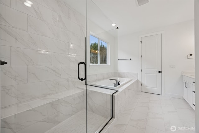 bathroom featuring a bath, marble finish floor, a stall shower, and vanity