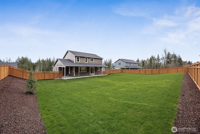 view of yard with a patio area and a fenced backyard