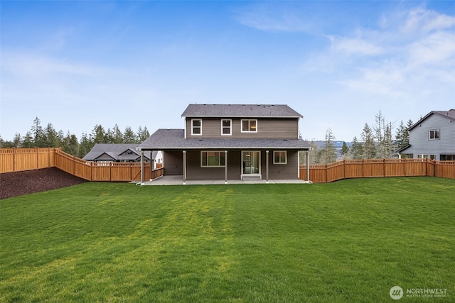 back of house with a yard, a fenced backyard, and a patio area