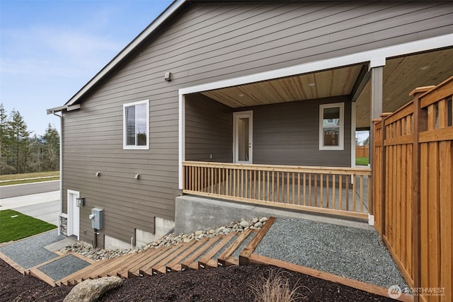 view of side of property featuring covered porch