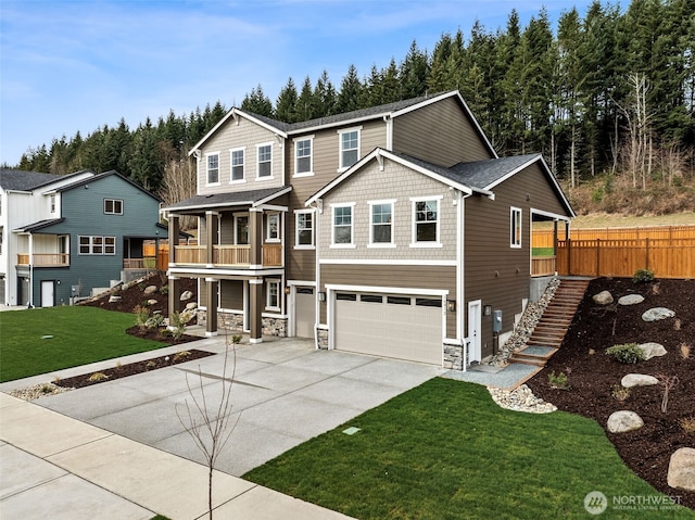 view of front of property with a front lawn, stone siding, concrete driveway, an attached garage, and stairs