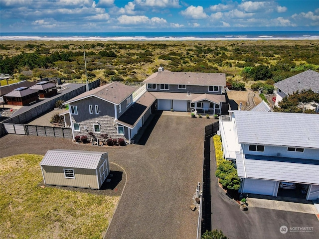 bird's eye view featuring a water view and a beach view