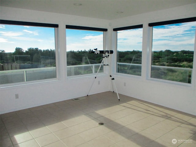 unfurnished sunroom with plenty of natural light