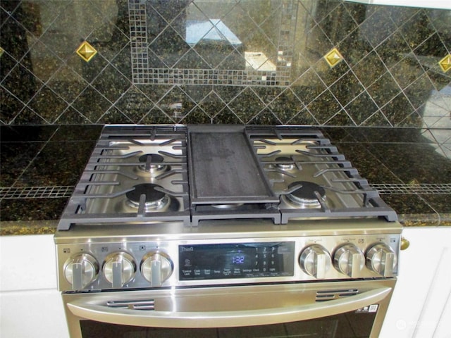 room details with backsplash and high end stainless steel range oven