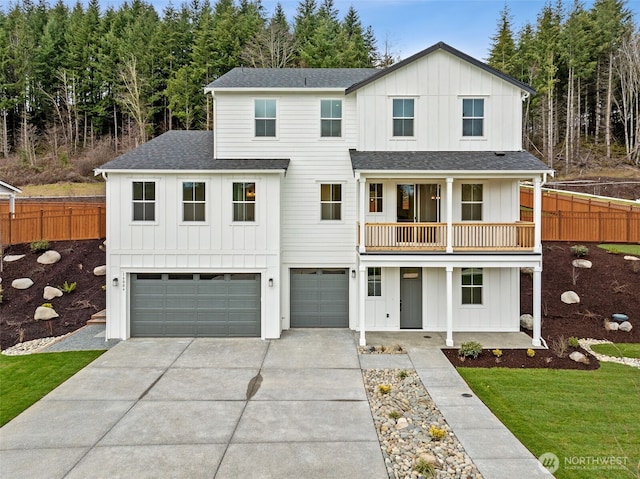 modern farmhouse style home with board and batten siding, an attached garage, and fence