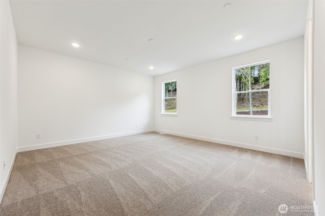 carpeted spare room with recessed lighting and baseboards