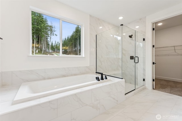 bathroom featuring a garden tub, marble finish floor, a stall shower, recessed lighting, and a spacious closet