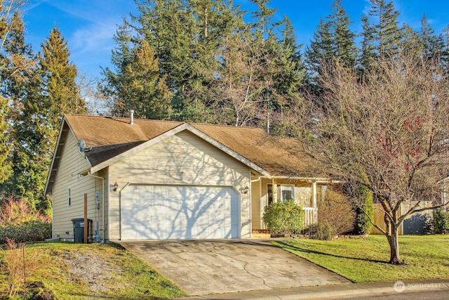 view of front of house with a garage and a front lawn