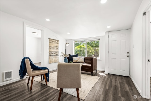 living room with dark hardwood / wood-style floors and vaulted ceiling