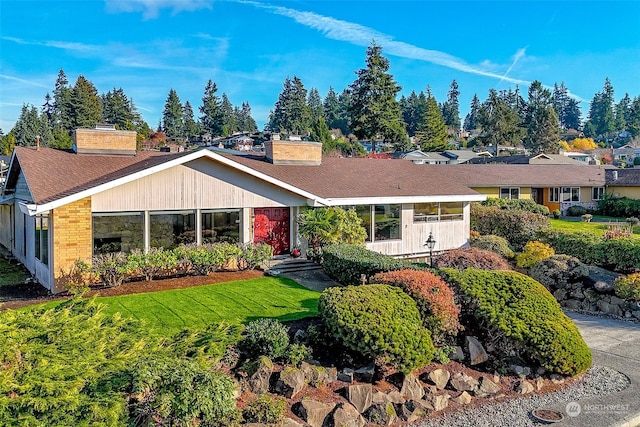 ranch-style house with a front lawn