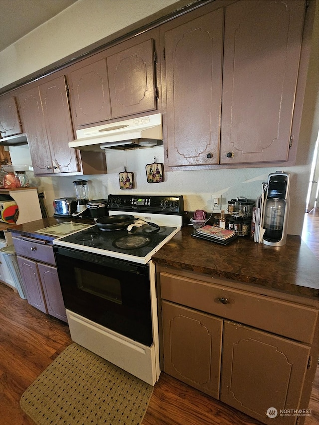 kitchen with white electric range oven and dark wood-type flooring