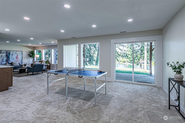 game room featuring light carpet