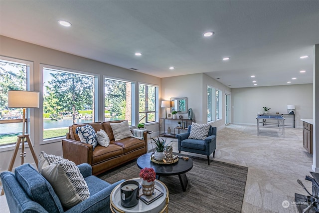 living room featuring light colored carpet and a wealth of natural light