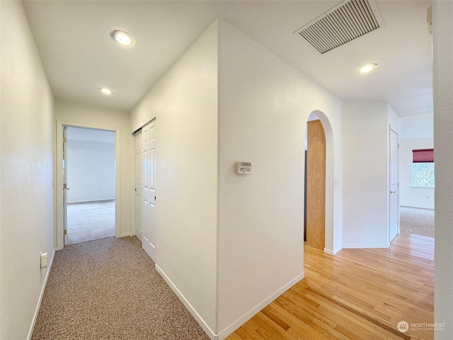 corridor with light hardwood / wood-style floors