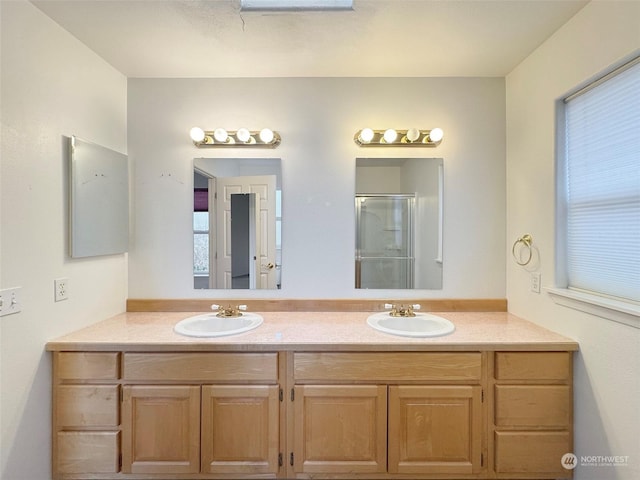 bathroom featuring vanity and a shower with door