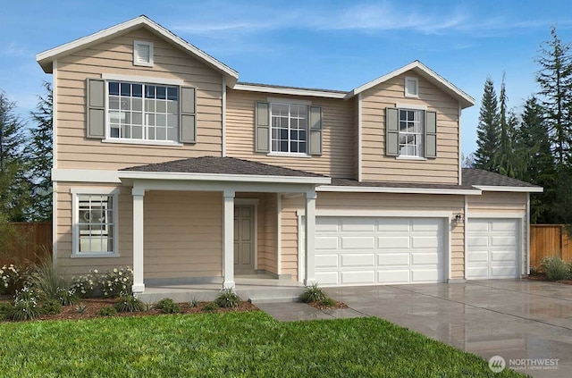 traditional-style home with concrete driveway, a garage, and fence