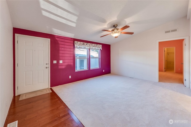 spare room featuring ceiling fan, vaulted ceiling, and hardwood / wood-style flooring