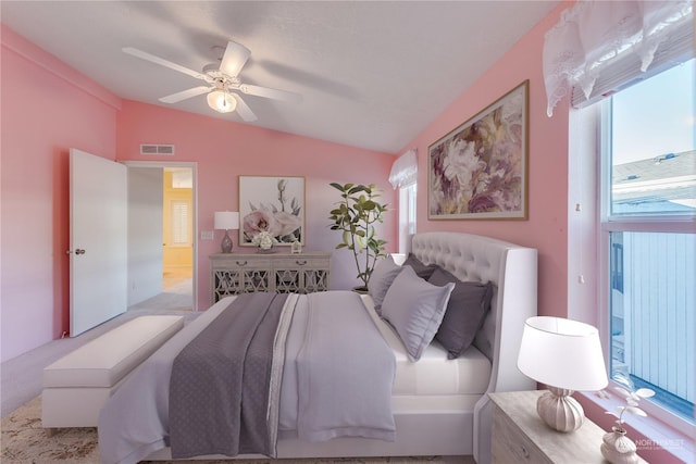 bedroom featuring ceiling fan, light colored carpet, and vaulted ceiling