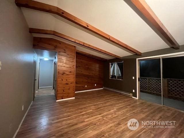 additional living space featuring baseboard heating, vaulted ceiling with beams, wood walls, and wood-type flooring