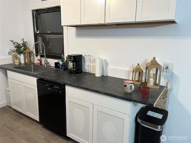 kitchen with white cabinetry, black dishwasher, and a sink