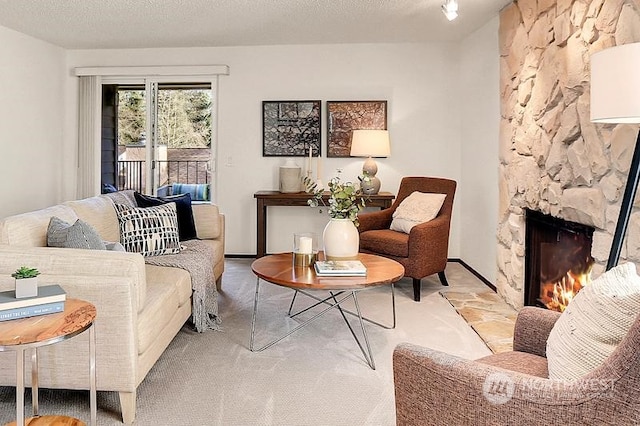 carpeted living room with a fireplace and a textured ceiling