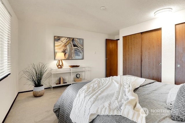 bedroom featuring a textured ceiling, carpet floors, and a closet