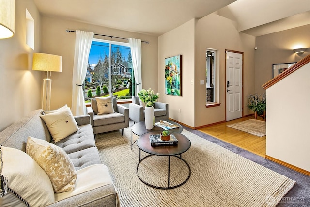 living area with baseboards and wood finished floors