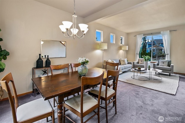 carpeted dining space featuring a notable chandelier and baseboards