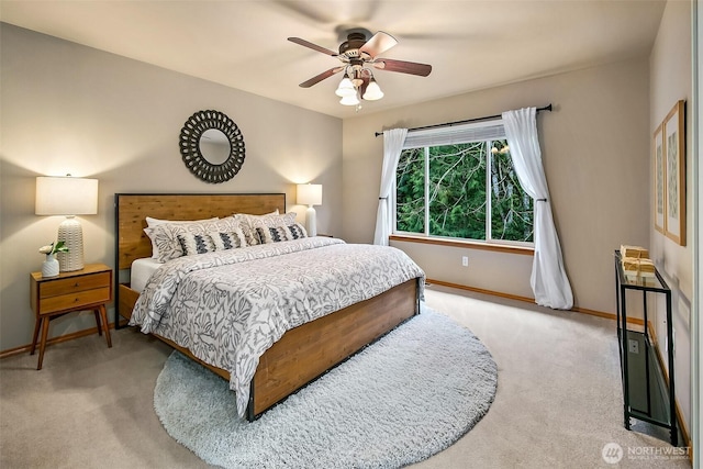 carpeted bedroom with a ceiling fan and baseboards