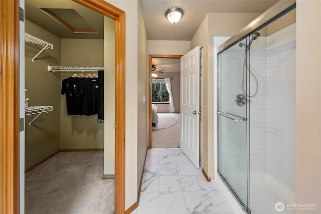 bathroom with marble finish floor, a shower stall, and connected bathroom