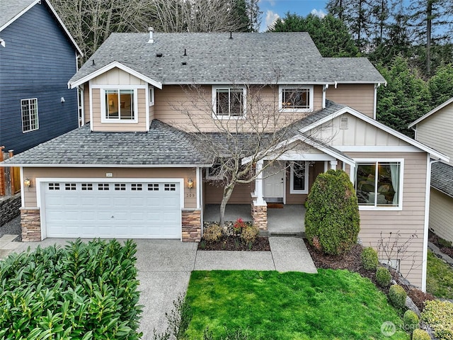 view of front facade featuring a shingled roof, board and batten siding, a garage, stone siding, and driveway