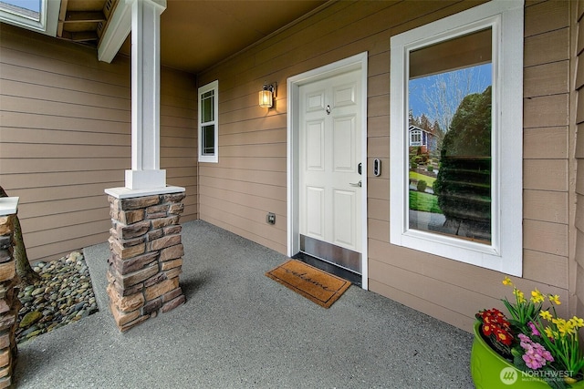 doorway to property featuring covered porch