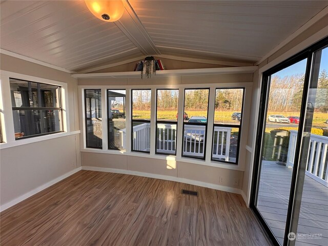 unfurnished sunroom with vaulted ceiling with beams and wooden ceiling