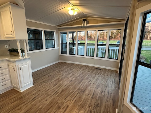 unfurnished sunroom with lofted ceiling and wood ceiling