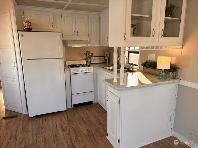 kitchen with white cabinets, white appliances, sink, and dark wood-type flooring