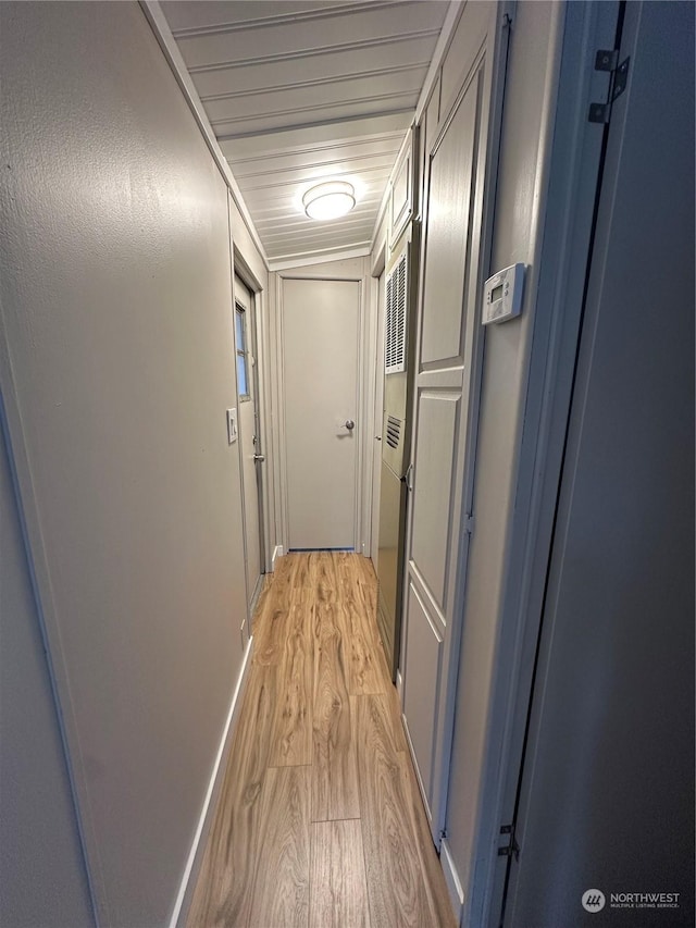 hallway with light hardwood / wood-style flooring