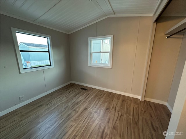 unfurnished room with vaulted ceiling with beams, ornamental molding, wood ceiling, and hardwood / wood-style flooring