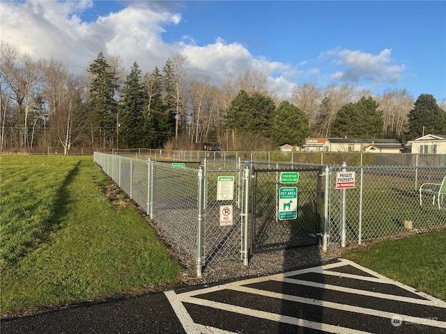 view of gate featuring a yard