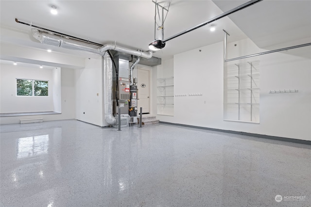 garage featuring a garage door opener and gas water heater