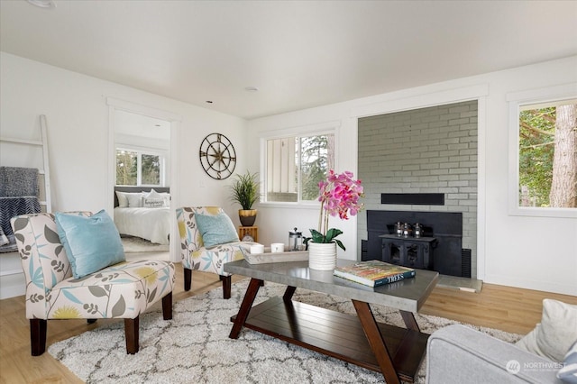 living room with plenty of natural light, wood-type flooring, and a fireplace