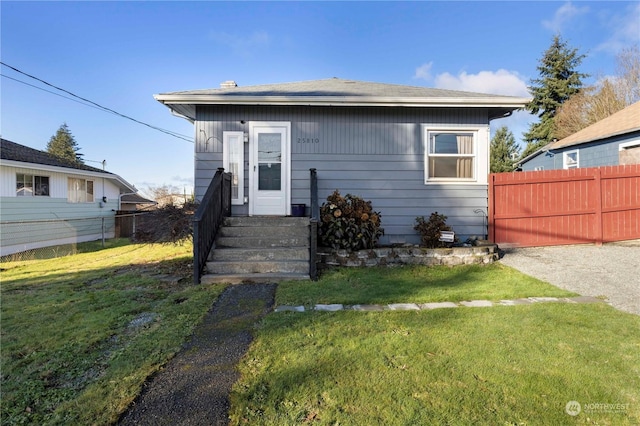 bungalow-style home featuring a front yard