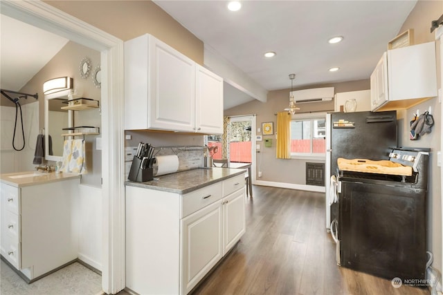 kitchen featuring lofted ceiling with beams, a wall mounted AC, pendant lighting, white cabinets, and hardwood / wood-style flooring