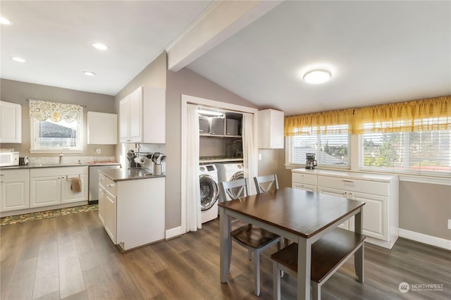 kitchen with washer / dryer, white cabinetry, plenty of natural light, and dark wood-type flooring