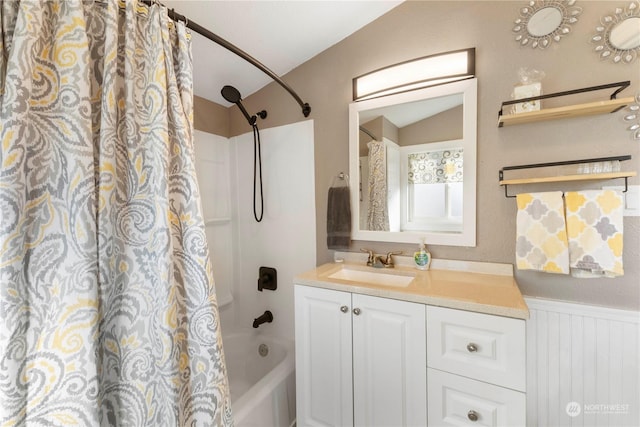 bathroom with vanity, lofted ceiling, and shower / bath combo with shower curtain