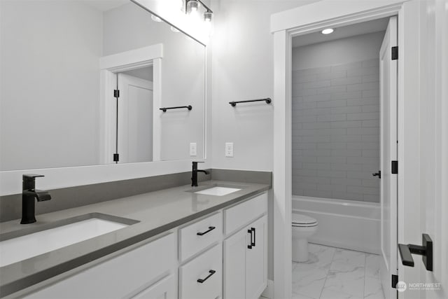 full bathroom featuring vanity, toilet, and tiled shower / bath