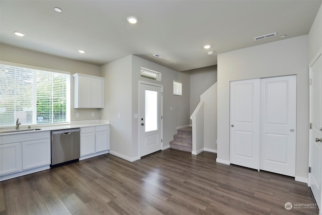 kitchen featuring white cabinetry, dishwasher, sink, and dark hardwood / wood-style flooring